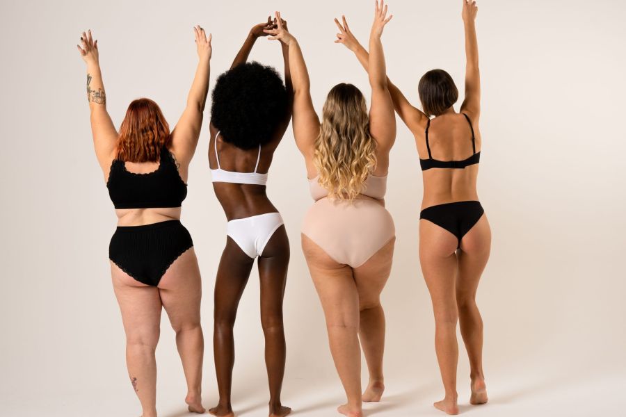 Group of women with different body and ethnicity dancing on the limbo together. Power and strength of women. Body positivity concept